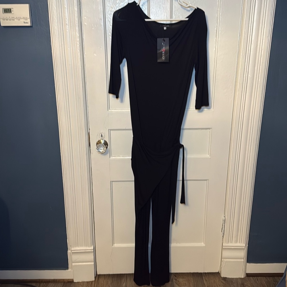 very stylish and cozy jumpsuit. 3/4 sleeve and wrap in front. NWT. XS